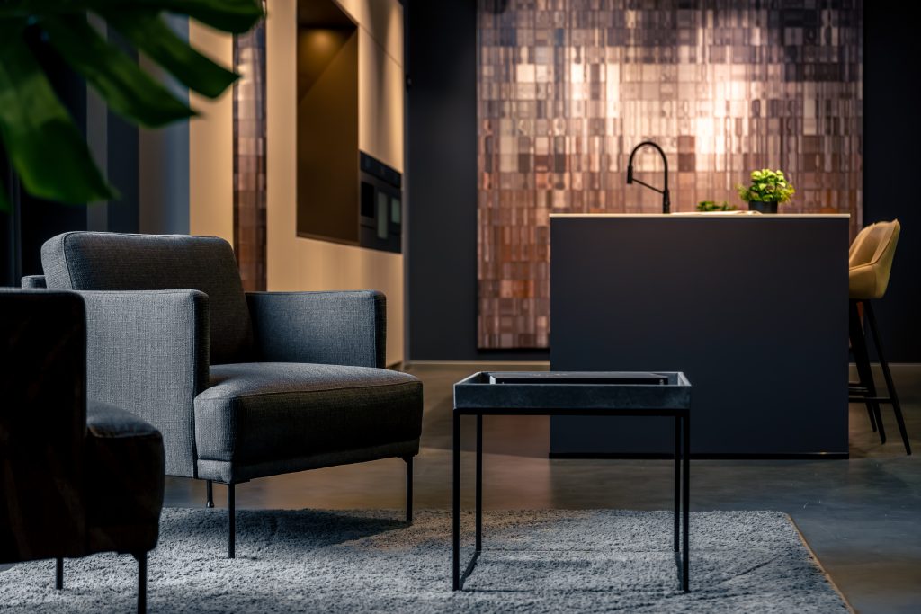 Spacious living room combined with dark kitchen area. Modern furniture and premium finish nobody.